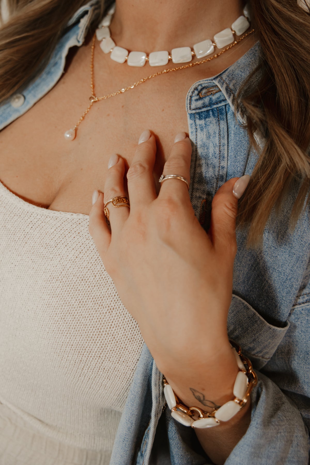 Rectangular white shell beads with gold accents and matching bracelet