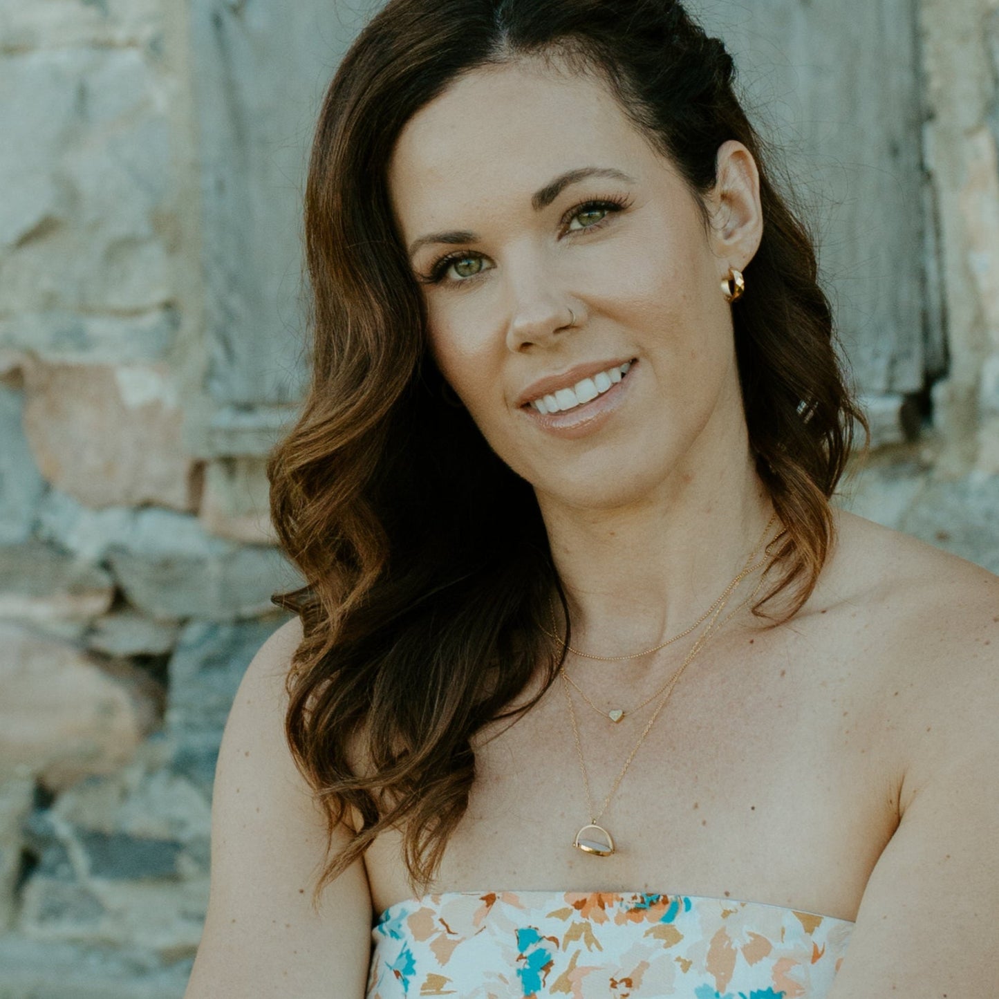 woman wearing initial heart necklace