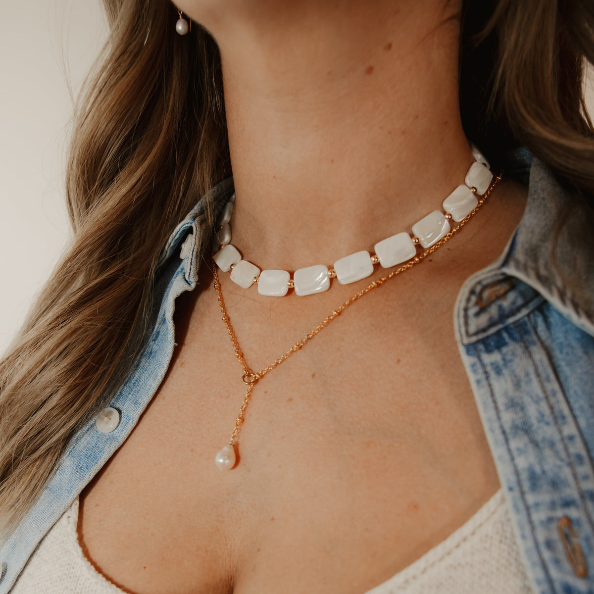 White rectangular shell beads with gold accents
