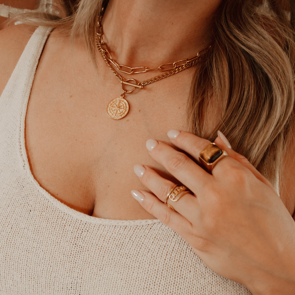 model wearing handmade layering gold necklaces