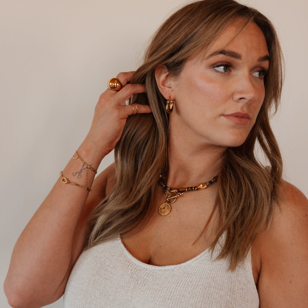 Model wearing Sloane gold leopard print hoop earrings by Isla Rae Jewelry