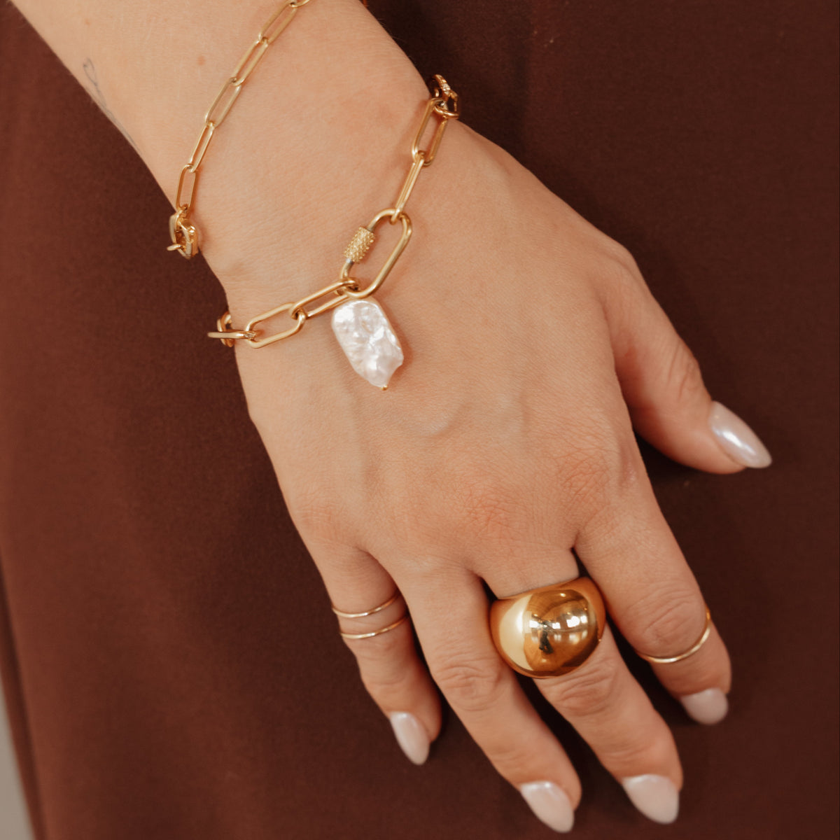 Customizable gold paperclip bracelet with meaningful charms