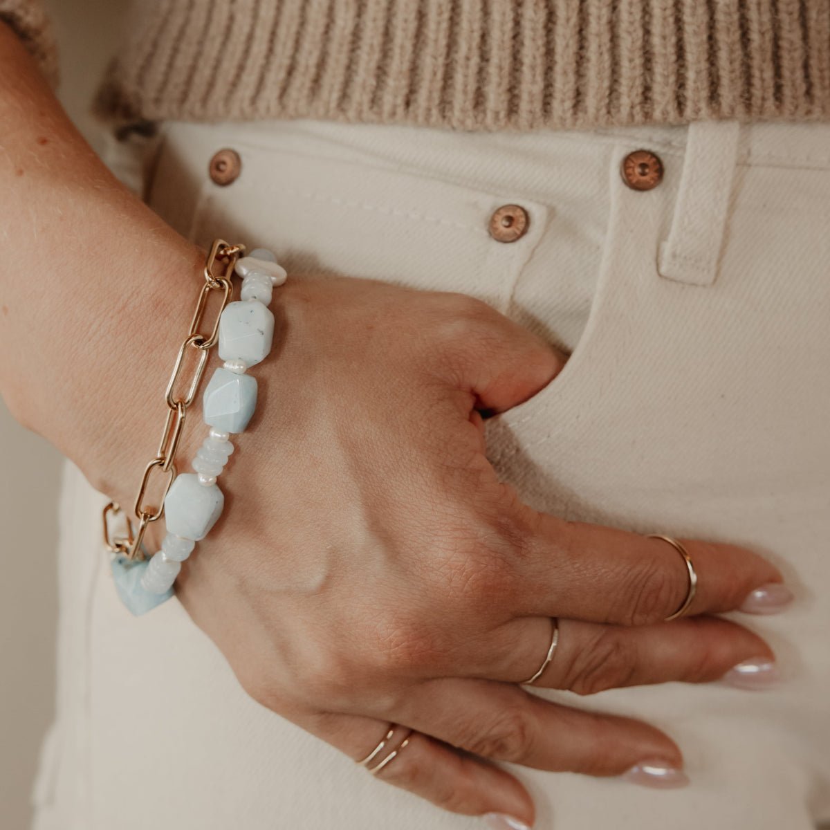 Handmade Claire blue jade and pearl bracelet layered with gold jewelry