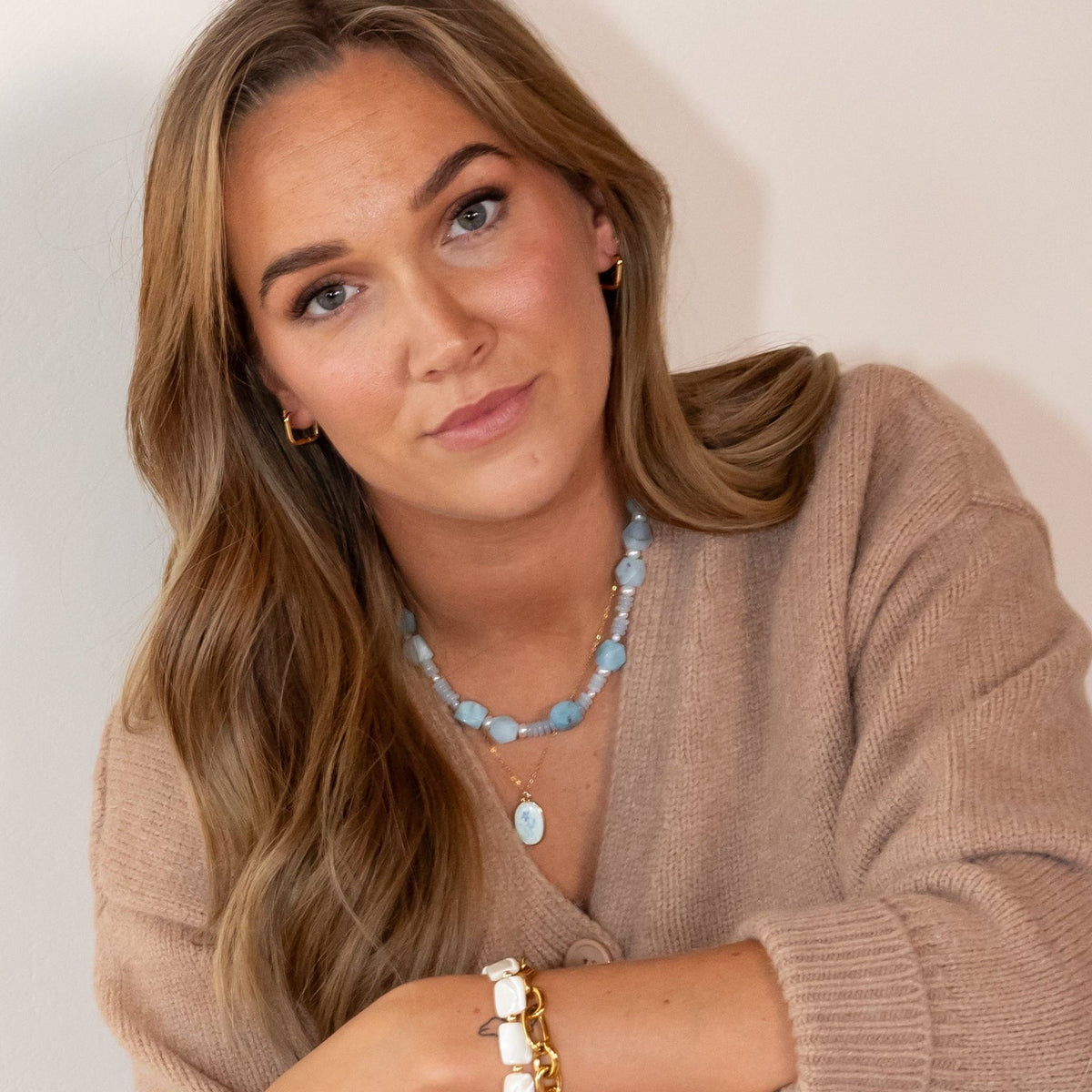 Handmade Claire blue jade and pearl bracelet layered with gold jewelry