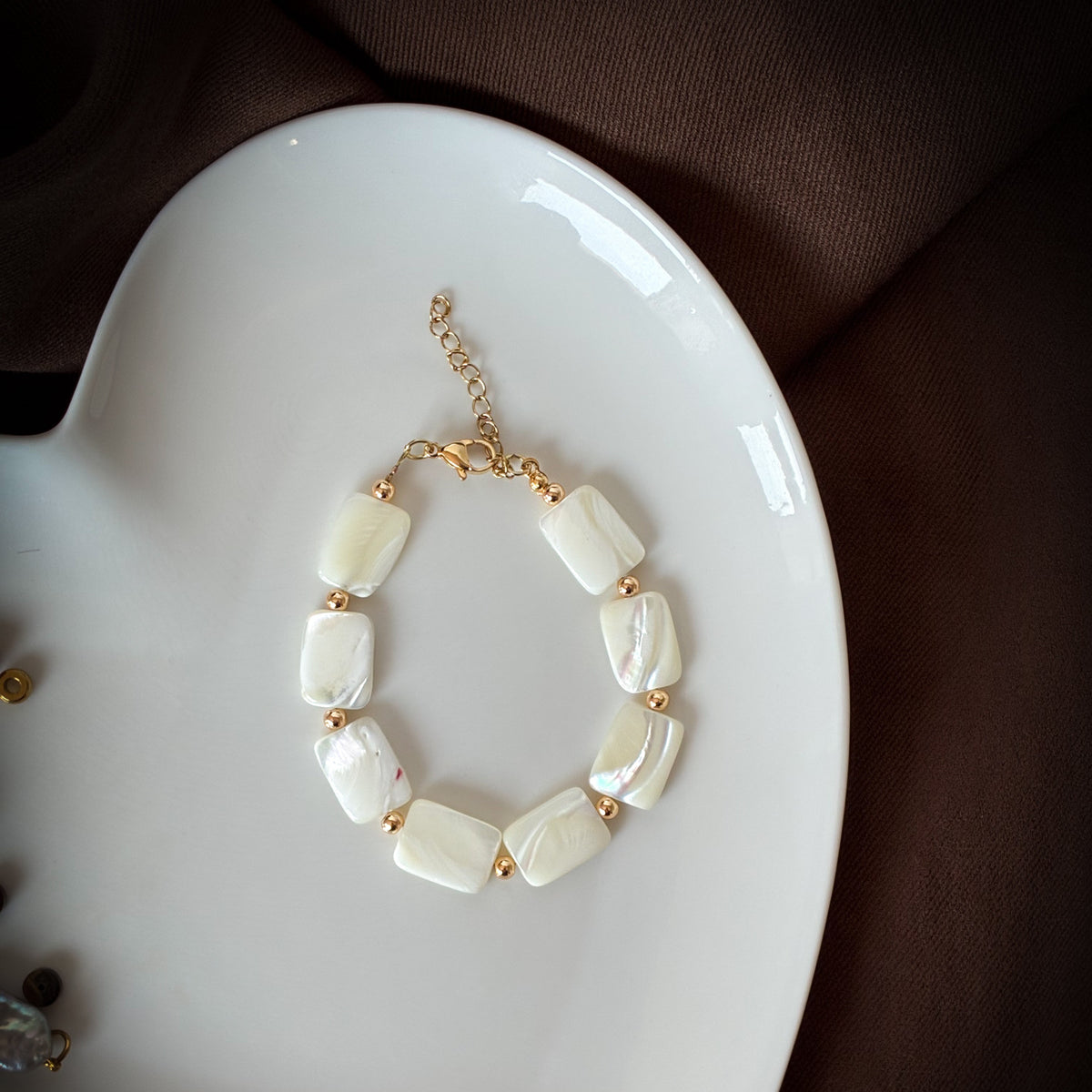 Rectangular white shell beads with gold accents