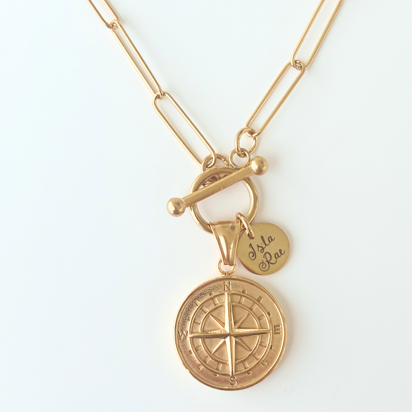 gold paperclip necklace with large compass pendant