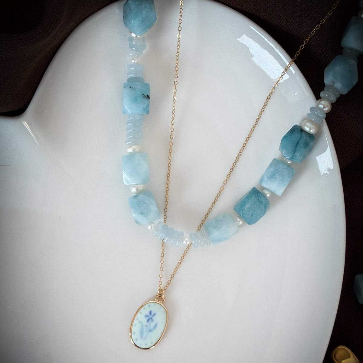Layering necklaces with gold and blue accents