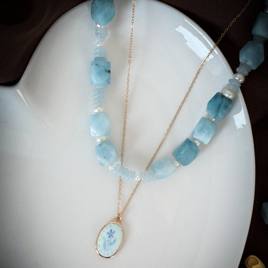 chunky blue jade with freshwater pearl accents, layered with painted blue flower necklace. handmade in canada